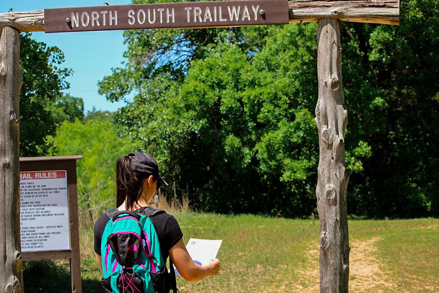 hiking-north-south-trailway Couple sitting in a chair, and smiling while looking at a map