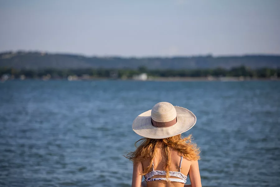 hat-woman-staring-at-lake-jpg Couple sitting in a chair, and smiling while looking at a map