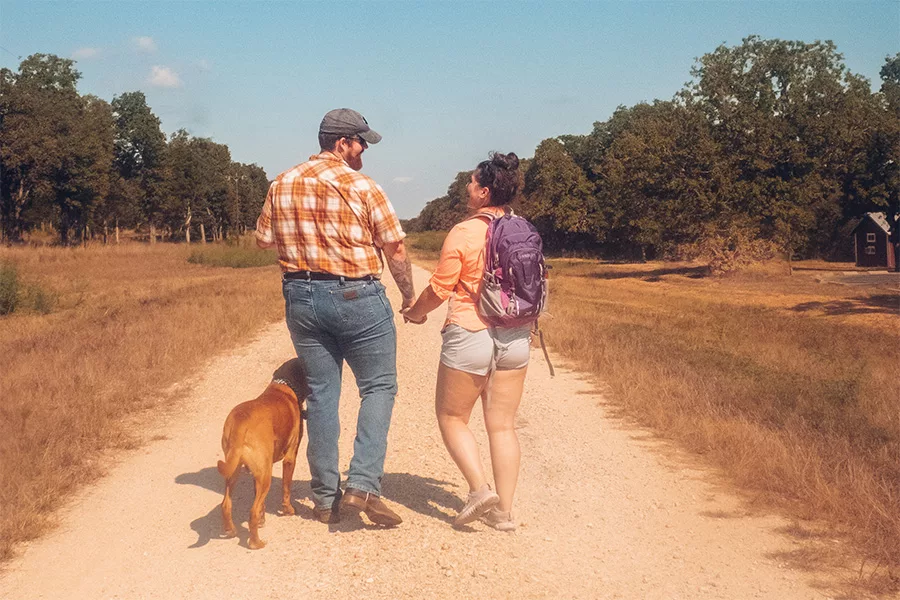couple walking with dog on trail jpg couple walking with dog on trail jpg
