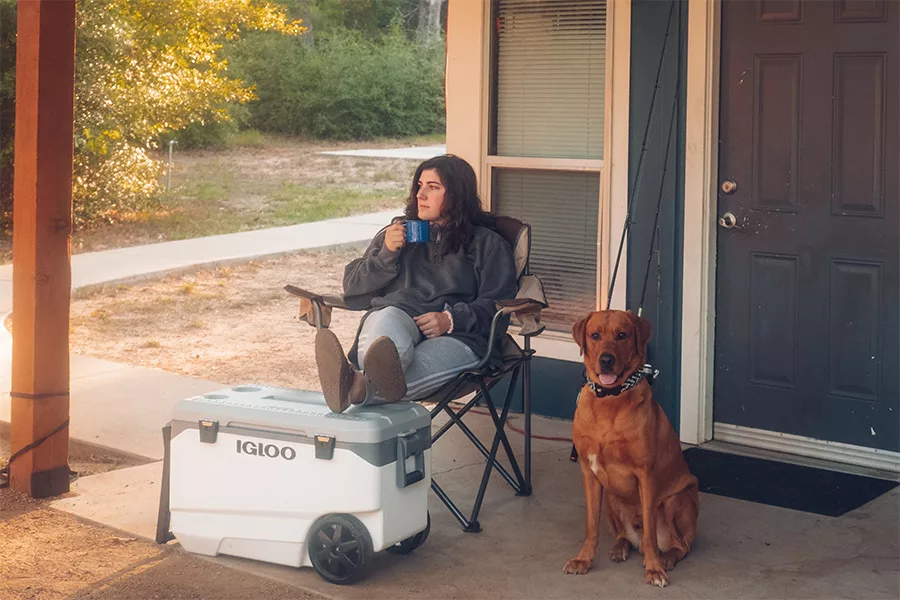 dog sitting with person on porch jpg